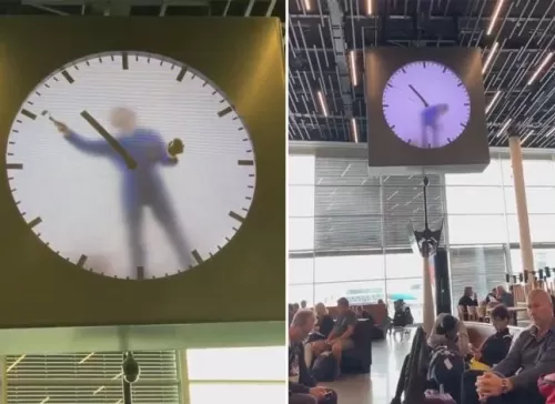 شاهد.. ساعة أغرب من الخيال بداخلها شخص يرسم عقاربها كل دقيقة في مطار بهولندا